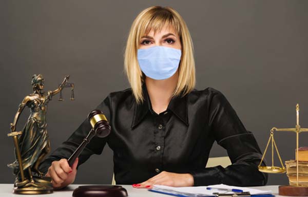 A young fair woman judge in protective mask works in her office.